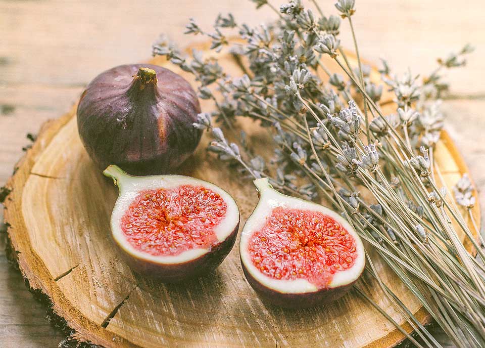 Composition of Israeli figs and herbs on a natural wood surface
